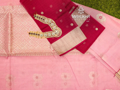 A pastel pink zari kota saree with red blouse