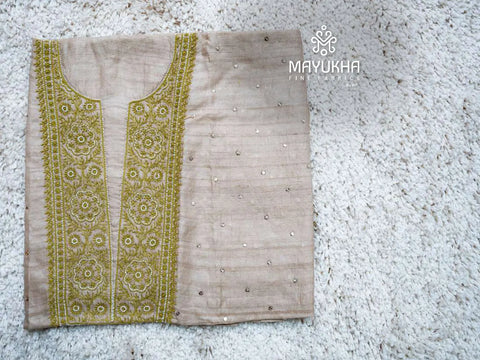 Beige tussar chikankari dress material with intricate green embroidered yoke