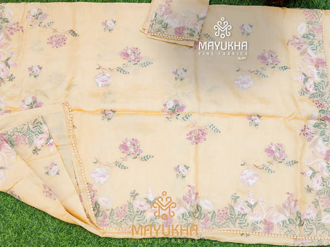 Cream colour tissue silk saree with delicate embroidered floral prints