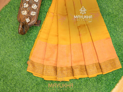 Yellow Chanderi saree with matching blouse.